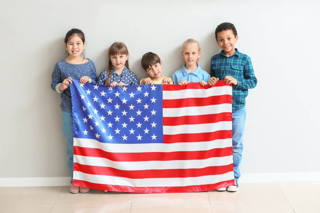 Little children are holding the United States Flag 