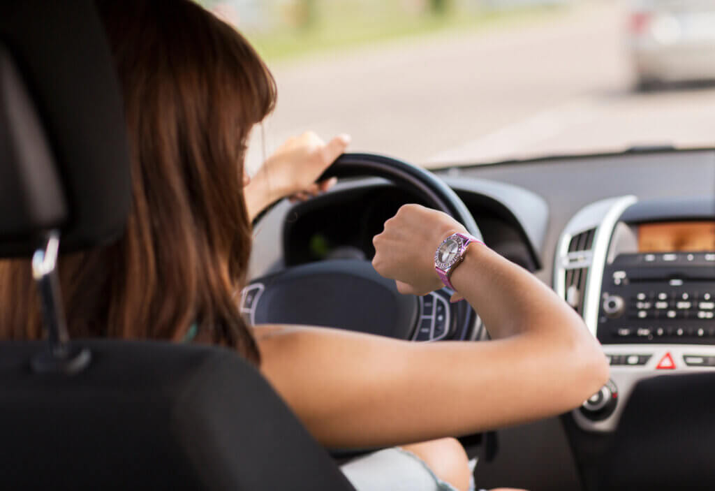 Woman in car running late for the morning meeting